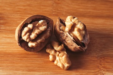 dried fruits, open nuts on wood