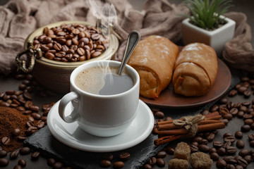 Coffee in a cup and saucer on an old background.