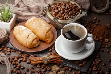 Coffee in a cup and saucer on an old background.