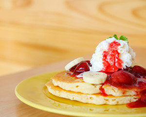 Buttermilk pancake filled with sliced banana and strawberries