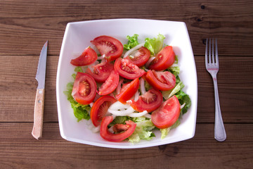 diet concept. bowl of lettuce, tomato and onion