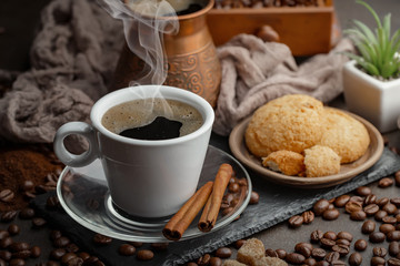 Coffee in a cup and saucer on an old background.