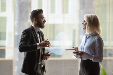 Diverse businesspeople discuss ideas cooperating in office