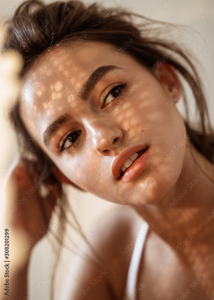 Wall mural portrait of a model on a sunny day shadows fall on the face and create a beautiful picture