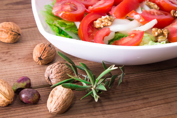 lettuce, tomato and walnut salad diet and food concept