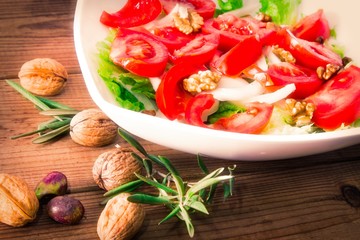 lettuce, tomato and walnut salad diet and food concept