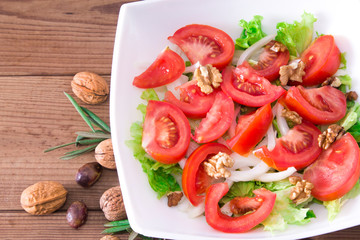 lettuce, tomato and walnut salad diet and food concept