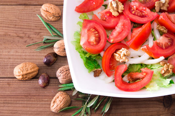 lettuce, tomato and walnut salad diet and food concept