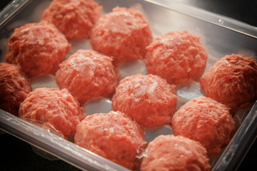 Frozen meatballs on a transparent substrate.