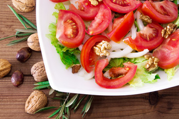 lettuce, tomato and walnut salad diet and food concept