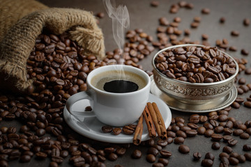 Coffee in a cup and saucer on an old background.