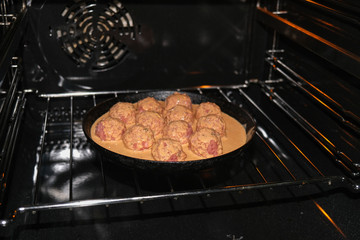 Semifinished. Cooking meatballs in the oven with sauce.