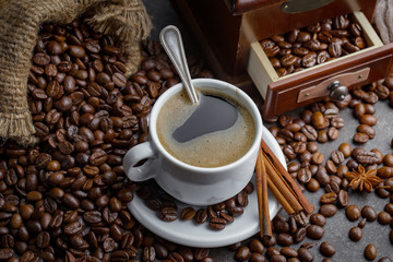 Coffee in a cup and saucer on an old background.