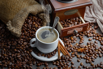 Coffee in a cup and saucer on an old background.