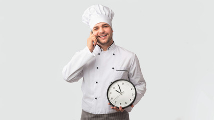 Chef Man Talking On Phone Holding Clock On White Background