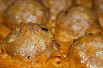 Delicious baked meatballs in the oven. Cooked in a creamy sauce. Selective focus.