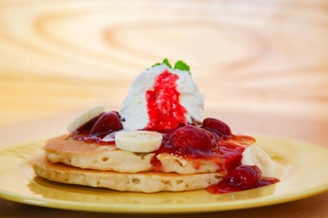 Buttermilk pancake filled with sliced banana and strawberries