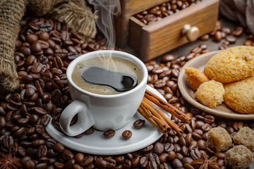 Coffee in a cup and saucer on an old background.