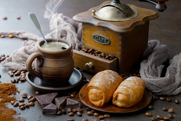 Coffee in a cup on a background of coffee beans, on an old background.