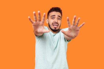 I'm afraid! Portrait of scared terrified brunette man with beard in white t-shirt making frightened...
