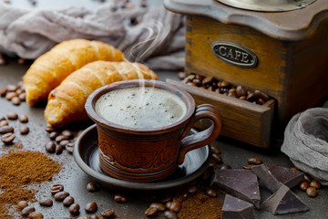 Coffee in a cup and saucer on an old background.