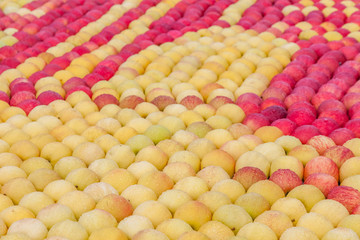 Background of lots of red and yellow apples cover with water drop
