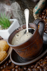 Coffee in a cup and saucer on an old background.