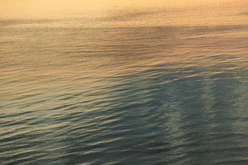 Beautiful amazing colurful gradient colors of sunset or sunrise sea water surface. Natural pastel organic background. Horizontal color photography,