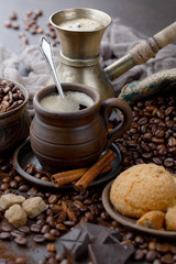 Coffee in a cup on a background of coffee beans, on an old background.