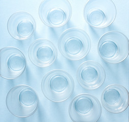 empty plastic disposable glasses on a light blue background