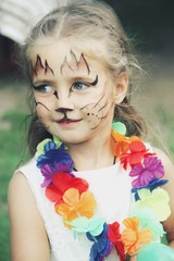 Portrait of little caucasian girl with bright fairy charachter make up