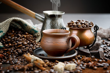 Coffee in a cup and saucer on an old background.
