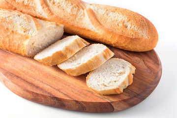 Freshly baked French baguettes on white wooden table.