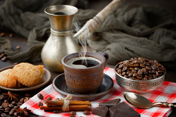 Coffee in a cup and saucer on an old background.