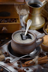 Coffee in a cup and saucer on an old background.