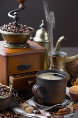 Coffee in a cup on a background of coffee beans, on an old background.