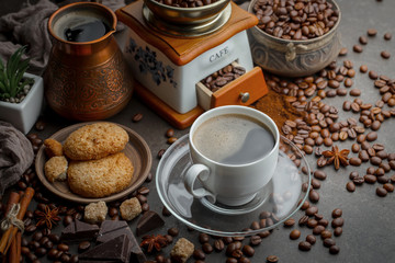 Coffee in a cup and saucer on an old background.