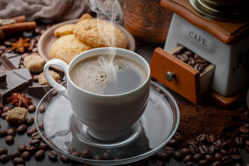 Coffee in a cup and saucer on an old background.