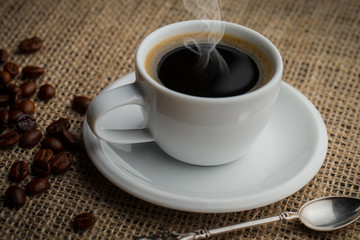 Coffee in a cup and saucer on an old background.