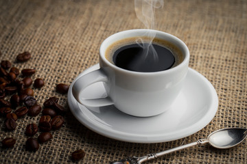 Coffee in a cup and saucer on an old background.