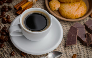 Coffee in a cup and saucer on an old background.