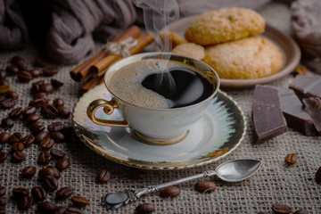 Coffee in a cup and saucer on an old background.