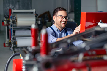 Industrial machine operator working in factory.