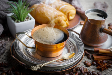 Coffee in a cup and saucer on an old background.
