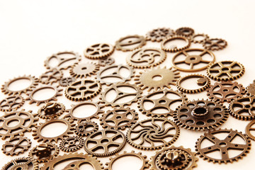 Background of vintage gears over wooden table, Aged mechanical clock wheels