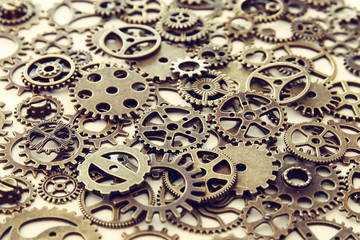 Background of vintage gears over wooden table, Aged mechanical clock wheels