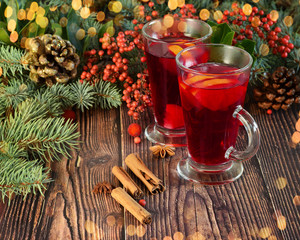 Traditional Christmas and New Year drink Mulled wine with cinnamon sticks, slices of orange and...