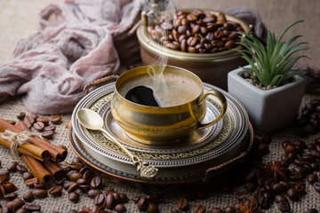 Coffee in a cup and saucer on an old background.
