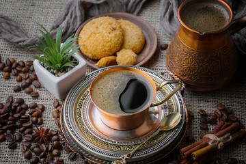 Coffee in a cup and saucer on an old background.