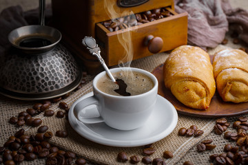 Coffee in a cup and saucer on an old background.